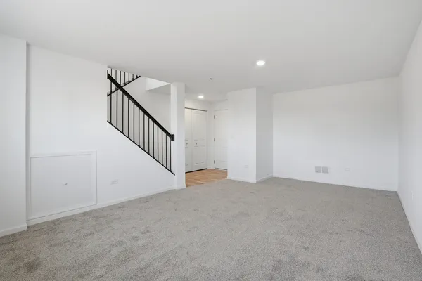 a view of an empty room with stairs