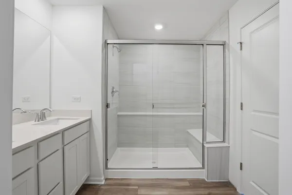 a bathroom with a shower and a sink