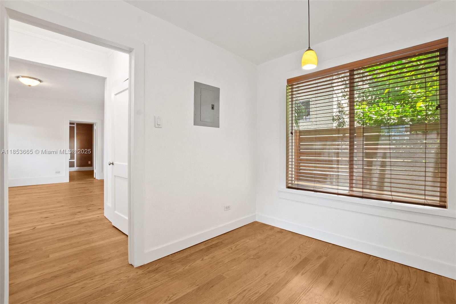 1721 Southwest 21st Terrace, Unit 1719 Miami, FL 33145 - Photo 14 of 25 a view of an empty room with wooden floor and a window