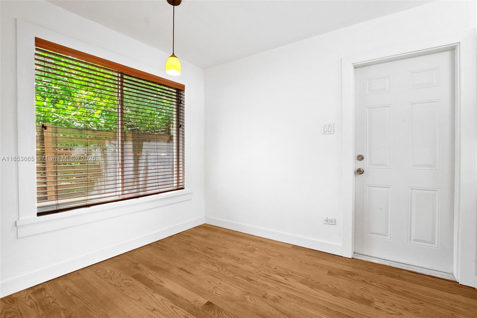 1721 Southwest 21st Terrace, Unit 1719 Miami, FL 33145 - Photo 15 of 25 a view of an empty room with wooden floor and a window