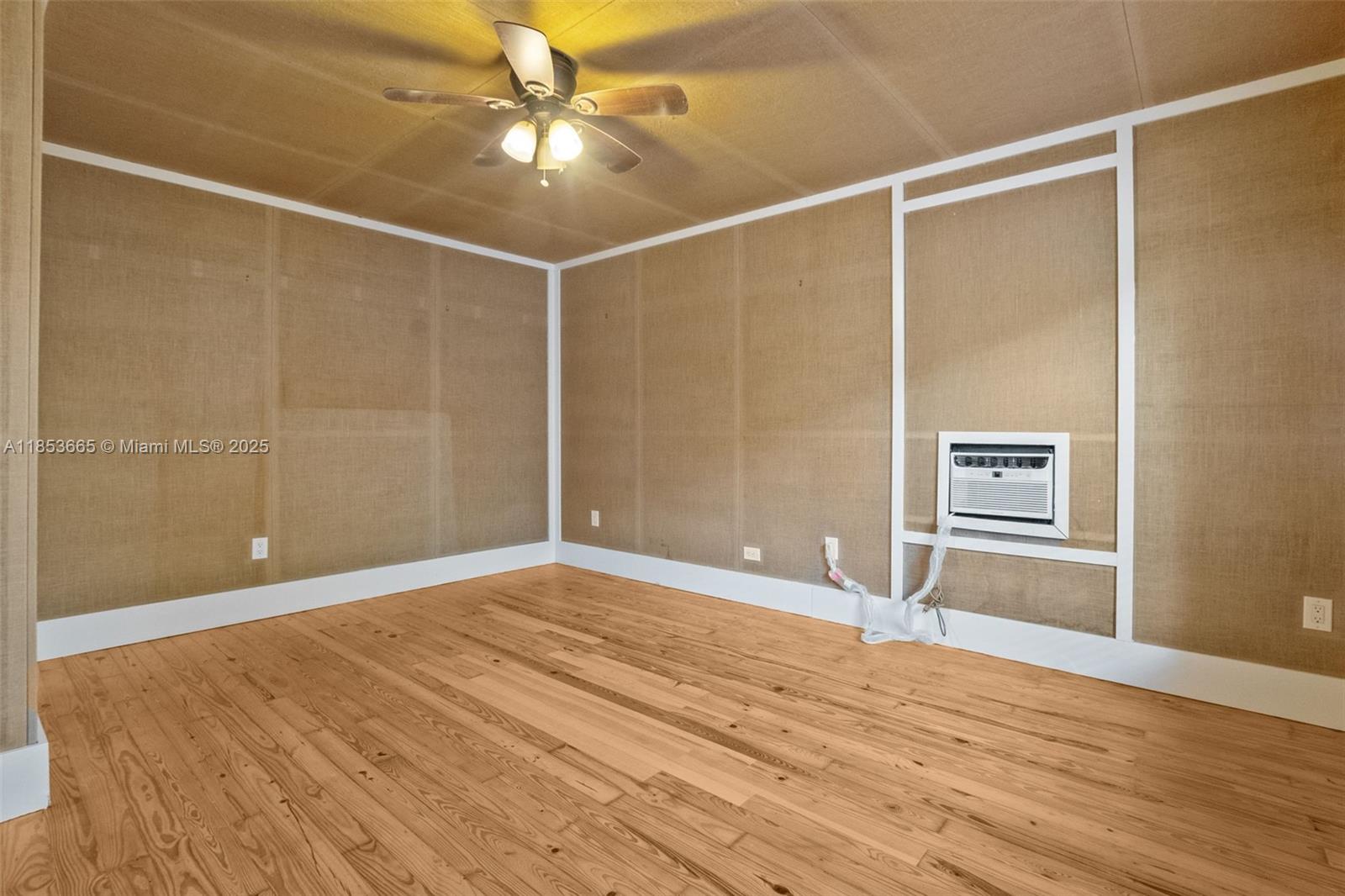 1721 Southwest 21st Terrace, Unit 1719 Miami, FL 33145 - Photo 17 of 25 a view of an empty room with wooden floor and a window
