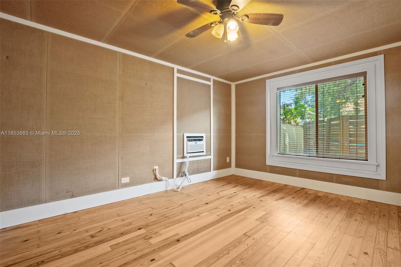 1721 Southwest 21st Terrace, Unit 1719 Miami, FL 33145 - Photo 19 of 25 a view of an empty room with a window and wooden floor