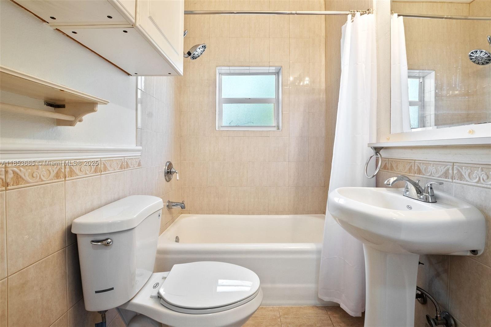 1721 Southwest 21st Terrace, Unit 1719 Miami, FL 33145 - Photo 21 of 25 a white toilet sitting next to a bathroom sink