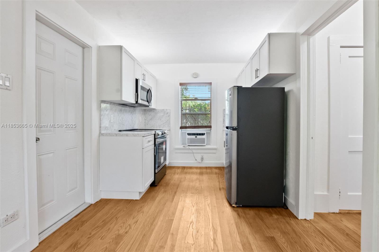 1721 Southwest 21st Terrace, Unit 1719 Miami, FL 33145 - Photo 4 of 25 a kitchen with a refrigerator and a stove top oven
