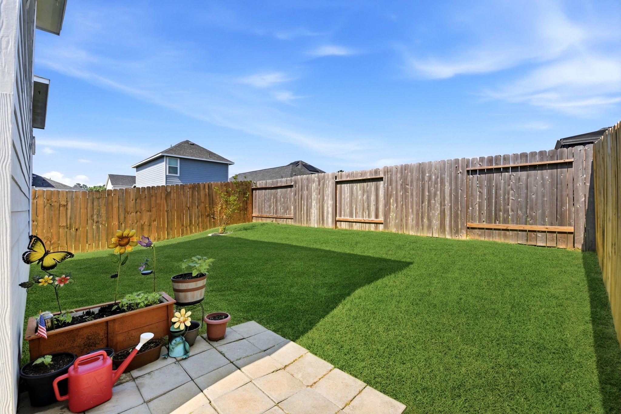 9819 Emerald Stone Way Conroe, TX 77306 - Photo 35 of 38 a view of a backyard with a garden and entertaining space