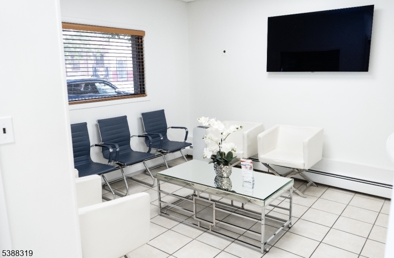 643 Elizabeth Avenue Elizabeth Port, NJ 07206 - Photo 20 of 36 a living room with furniture and a flat screen tv