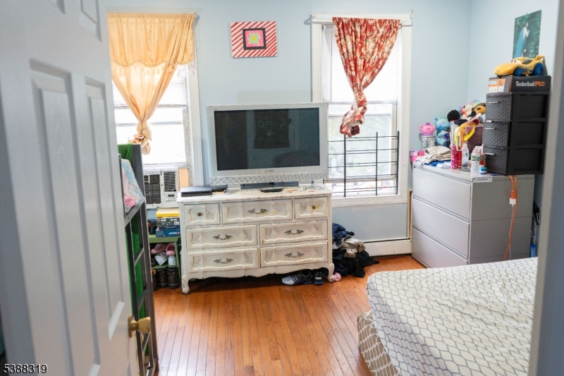 643 Elizabeth Avenue Elizabeth Port, NJ 07206 - Photo 3 of 36 a bedroom with a bed and flat screen tv