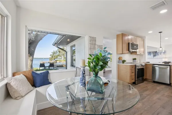 a living room with furniture kitchen and a table