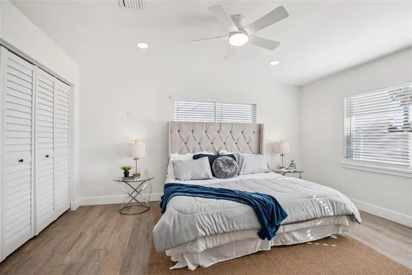 a bedroom with a large bed and a chandelier
