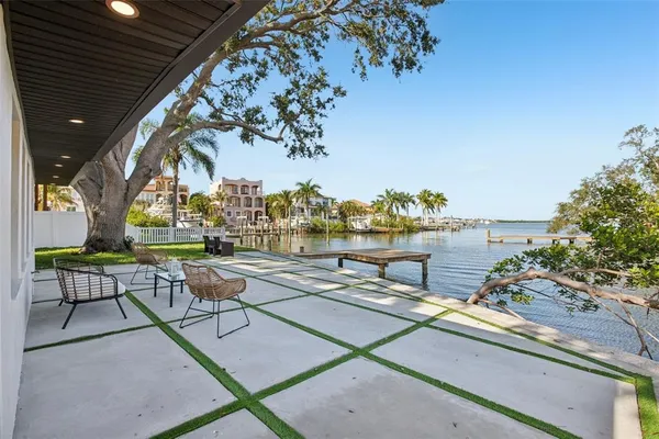a backyard of a house with table and chairs