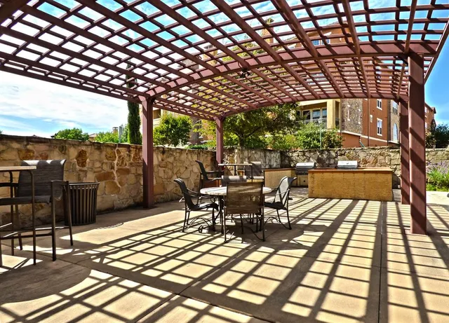 a view of a patio with a table and chairs next to a yard