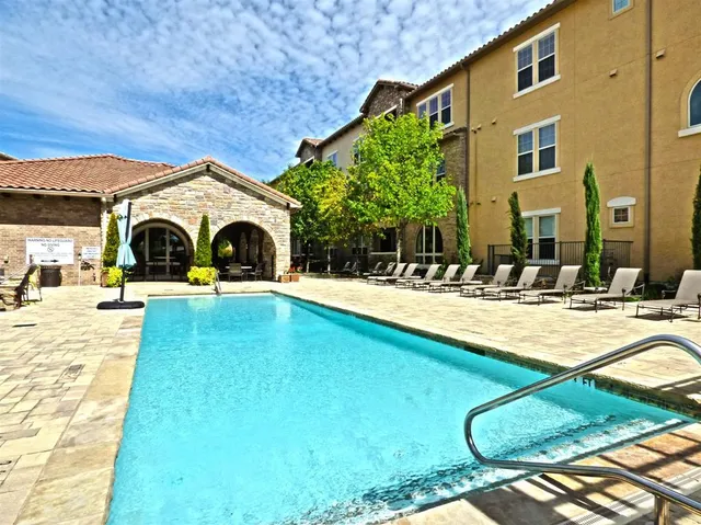 a swimming pool with outdoor seating and yard