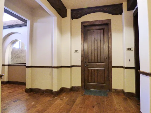 a view of an entryway with wooden floor