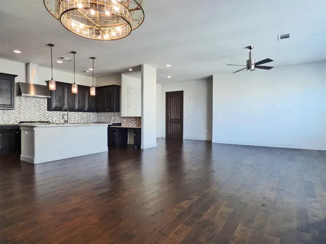 a view of kitchen with stove and cabinets