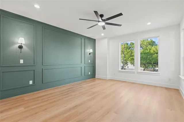 a view of a livingroom with a ceiling fan and window