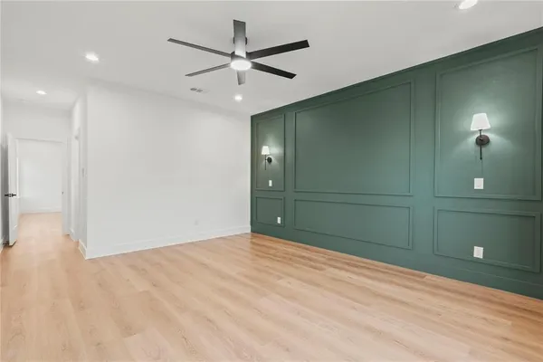 an empty room with closet and fan