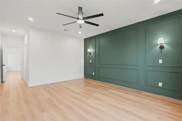 an empty room with closet and fan