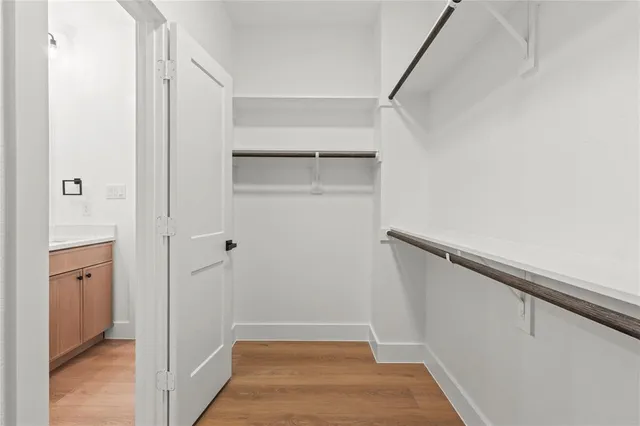 a view of walk in closet with empty racks