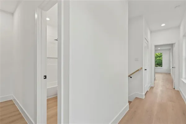 a view of a hallway with wooden floor