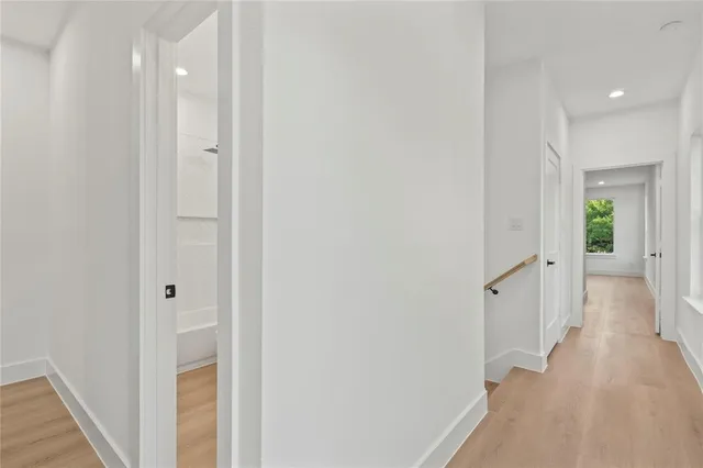 a view of a hallway with wooden floor