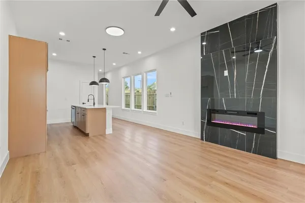 a view of kitchen with refrigerator and white wall