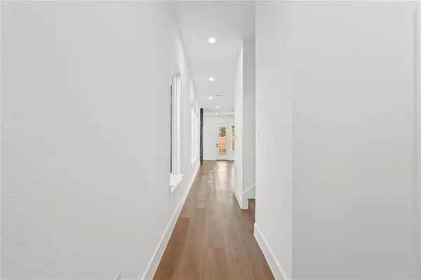 a view of a hallway with wooden floor