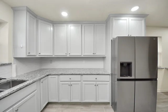 a kitchen with cabinets and stainless steel appliances