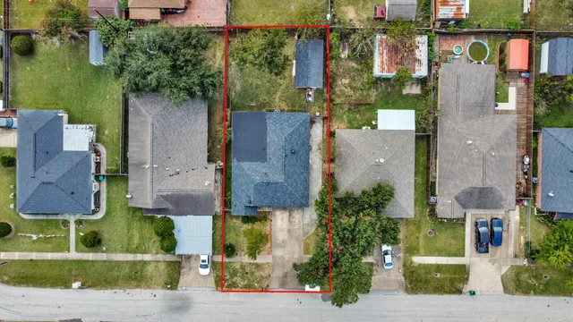 an aerial view of a house with a yard basket ball court and outdoor seating