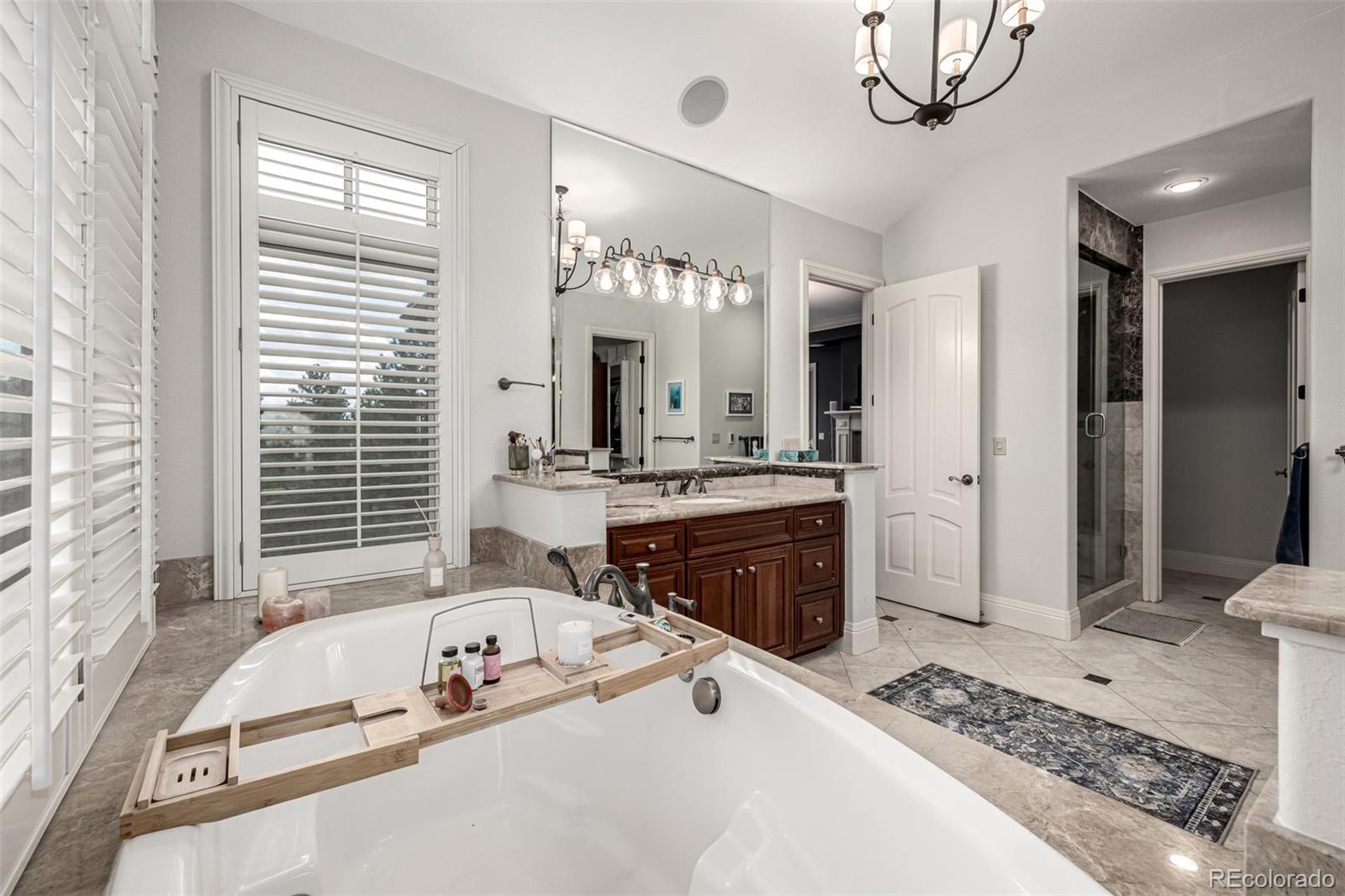 648 Ruby Trust Drive Castle Rock, CO 80108 - Photo 25 of 49 a spacious bathroom with a tub sink shower and mirror