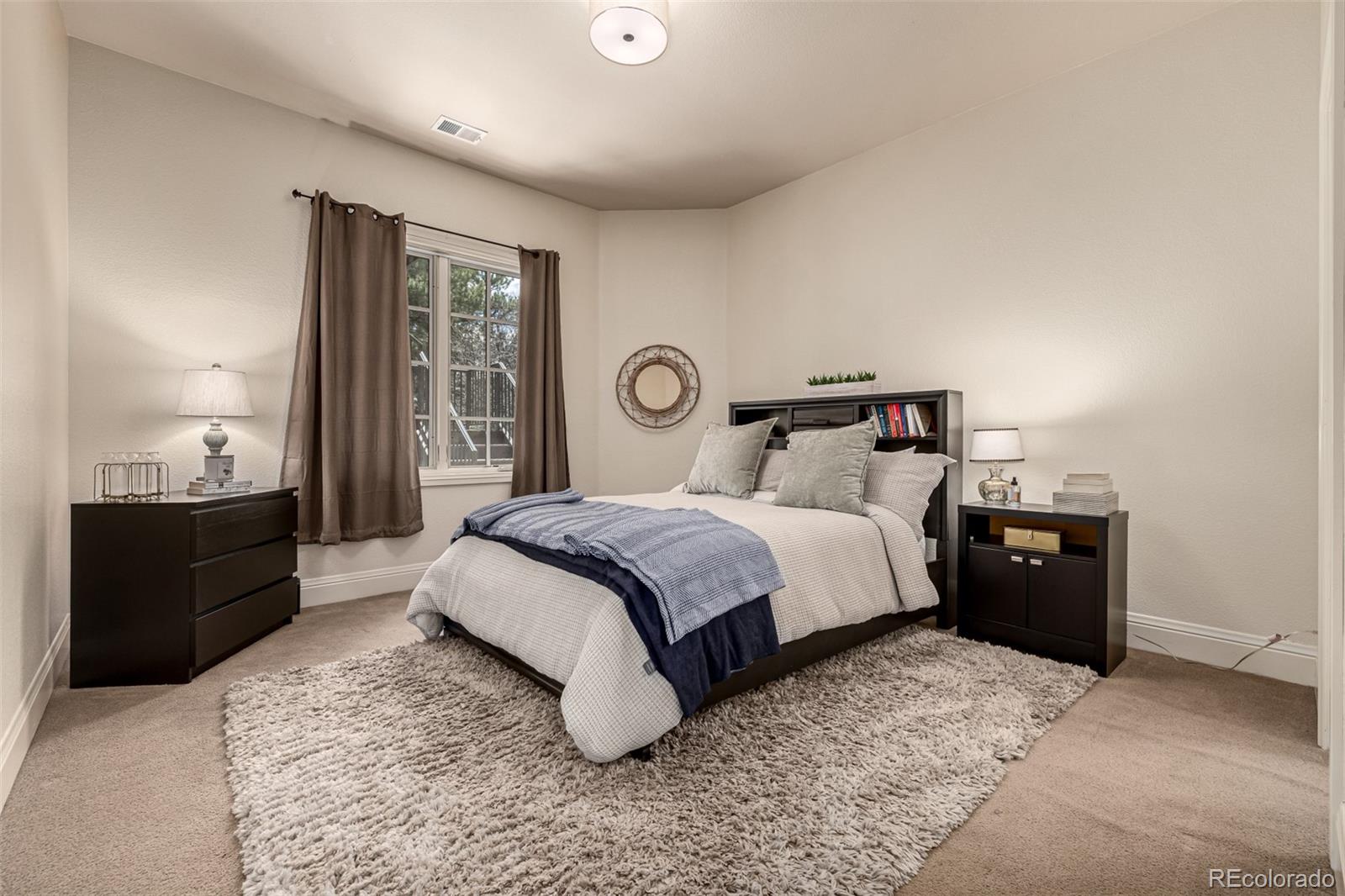 648 Ruby Trust Drive Castle Rock, CO 80108 - Photo 40 of 49 a bedroom with a bed and wooden floor