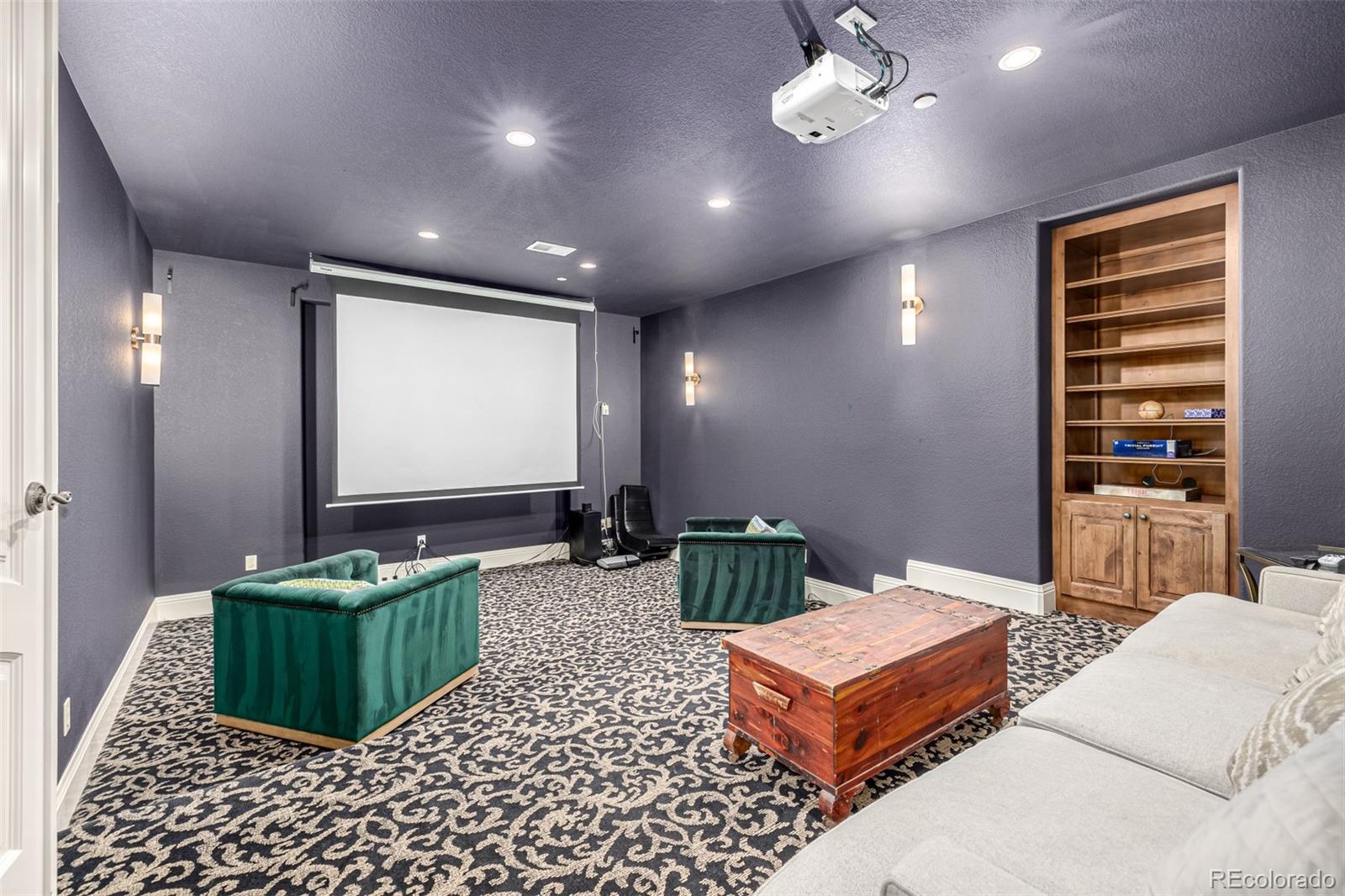648 Ruby Trust Drive Castle Rock, CO 80108 - Photo 42 of 49 a living room with furniture a rug and a flat screen tv
