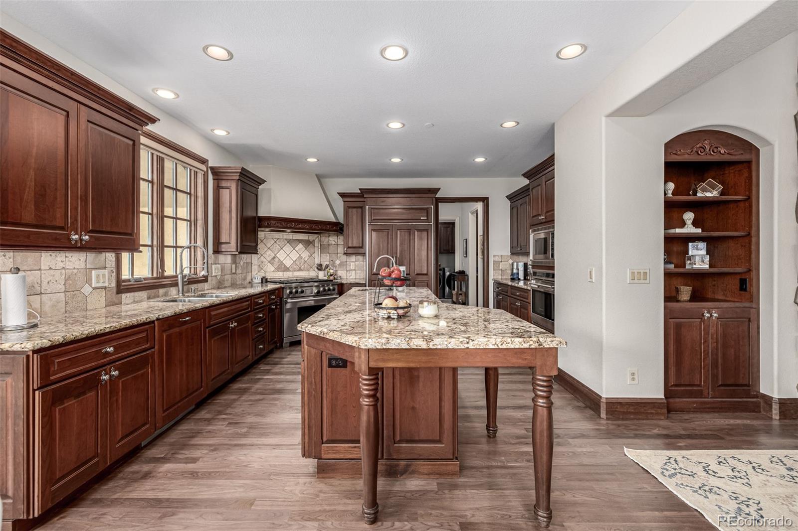 648 Ruby Trust Drive Castle Rock, CO 80108 - Photo 9 of 49 a kitchen with stainless steel appliances granite countertop a refrigerator and a stove top oven