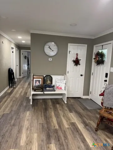 a view of a workspace with furniture and wooden floor