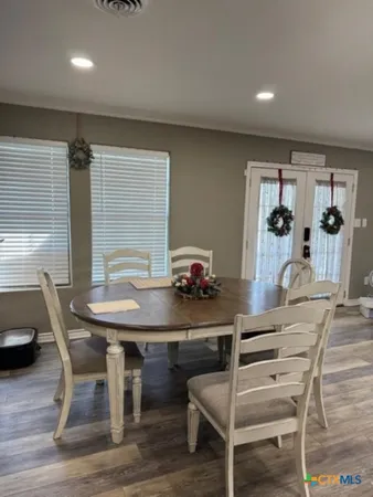 a view of a dining room with furniture and window