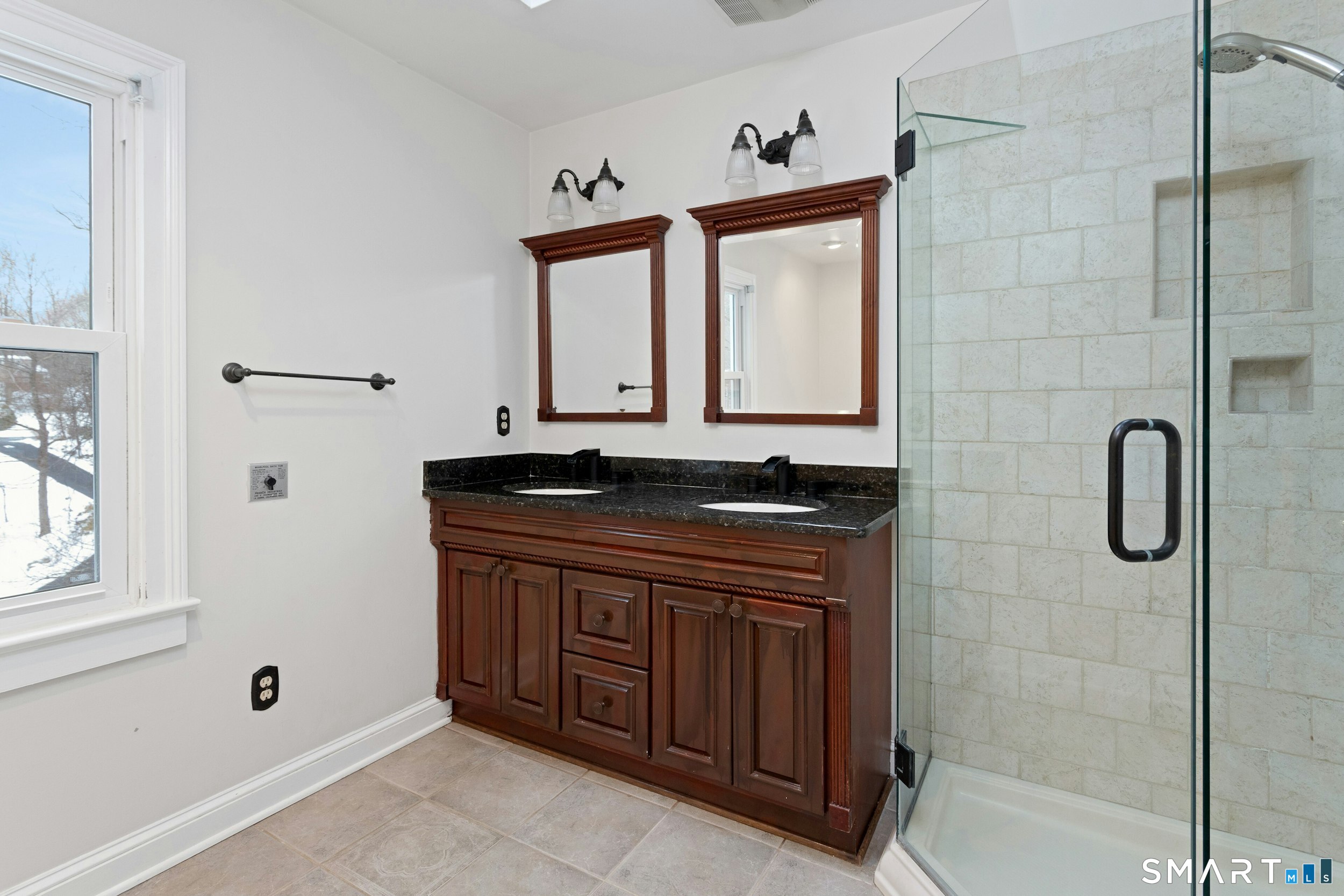 6 Morganti Court Ridgefield, CT 06877 - Photo 11 of 36 a bathroom with a granite countertop sink a mirror and shower