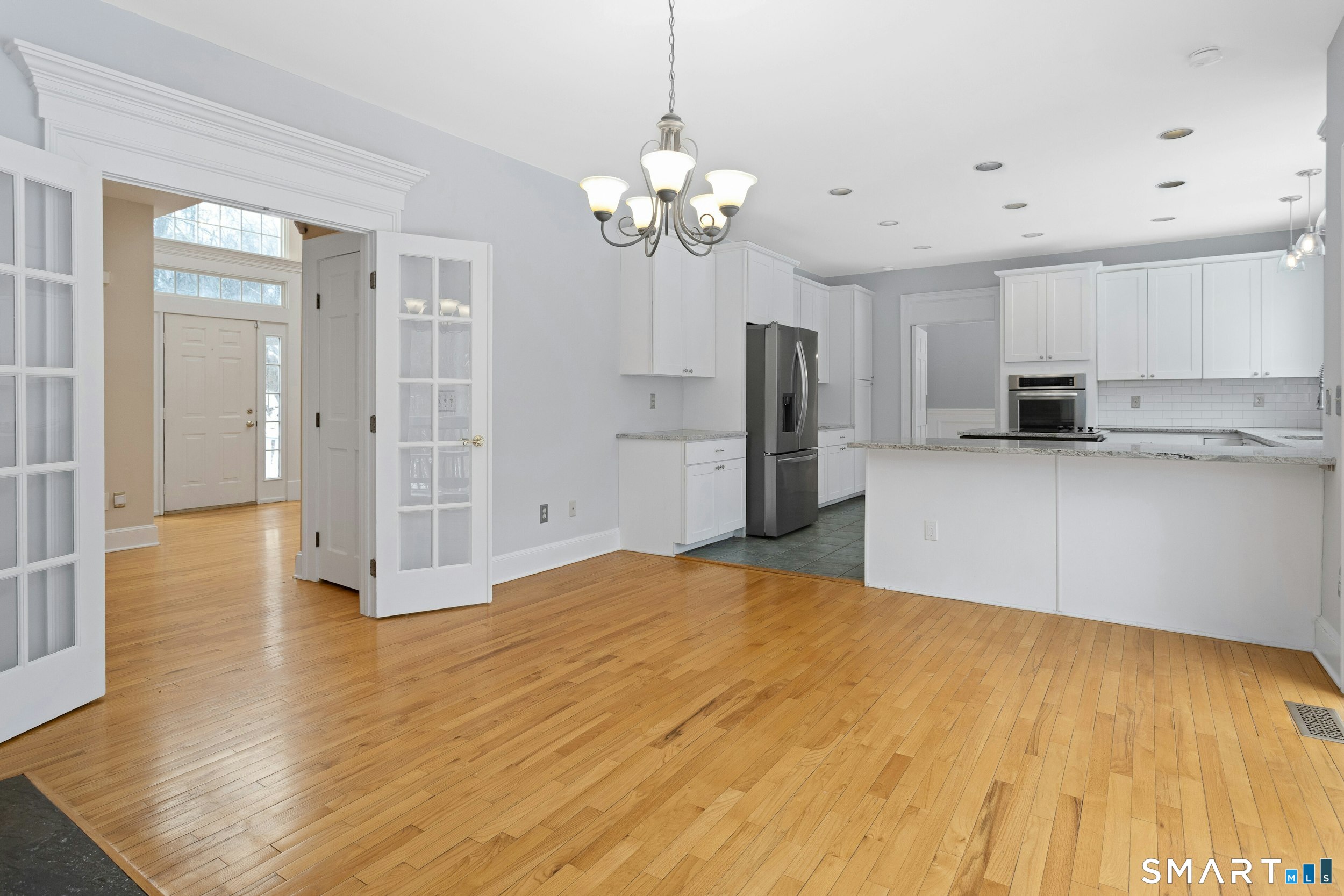 6 Morganti Court Ridgefield, CT 06877 - Photo 12 of 36 a view of a kitchen with a sink dishwasher a refrigerator with wooden floor and cabinets