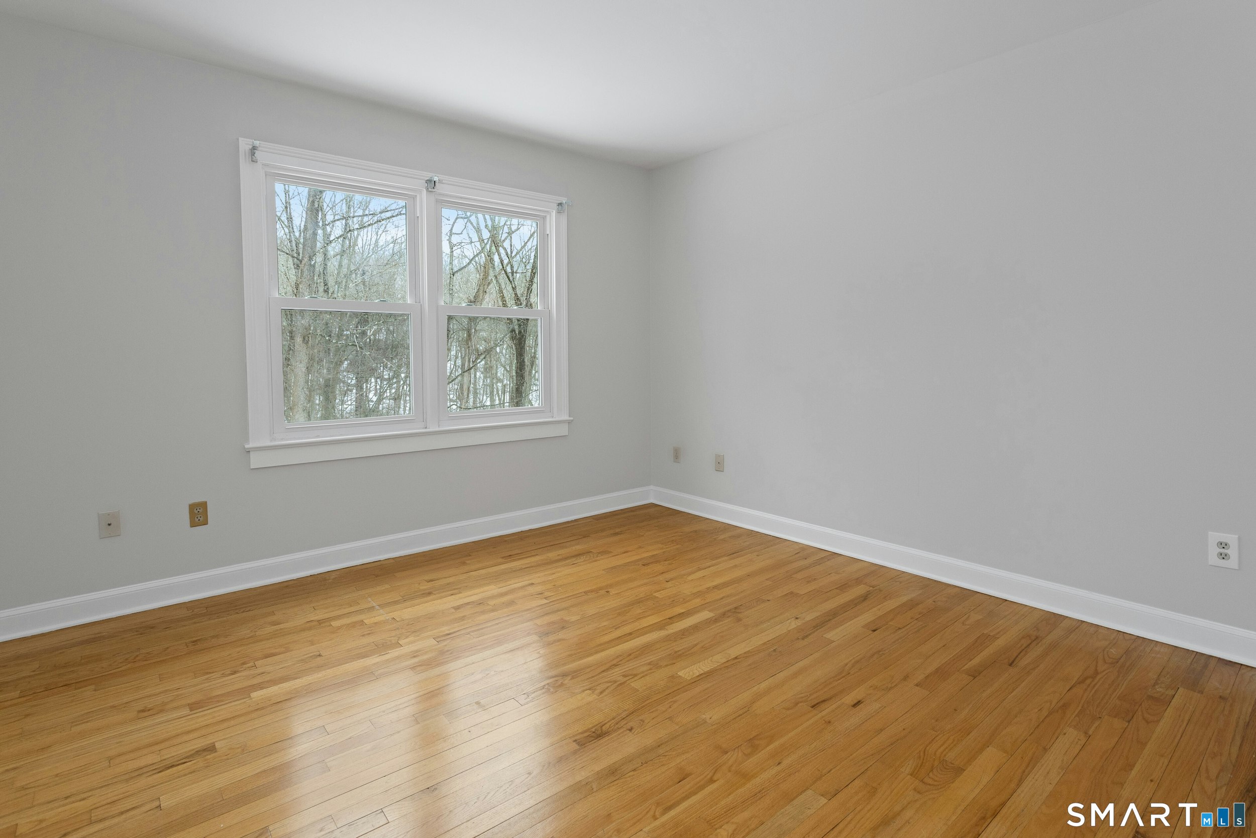 6 Morganti Court Ridgefield, CT 06877 - Photo 17 of 36 an empty room with wooden floor and windows