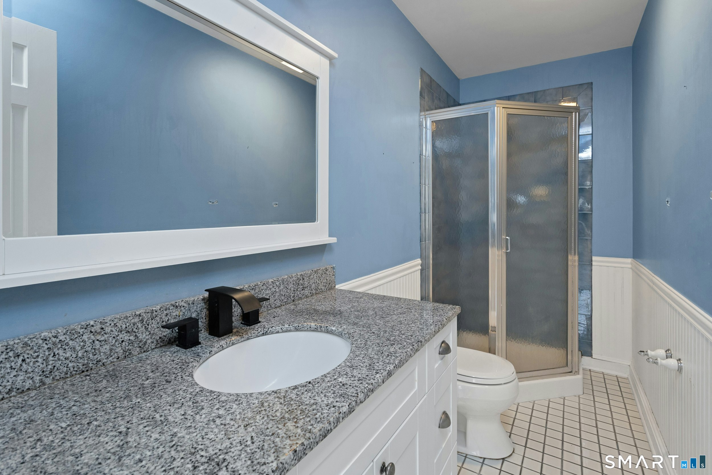 6 Morganti Court Ridgefield, CT 06877 - Photo 18 of 36 a bathroom with a granite countertop sink toilet a mirror and shower