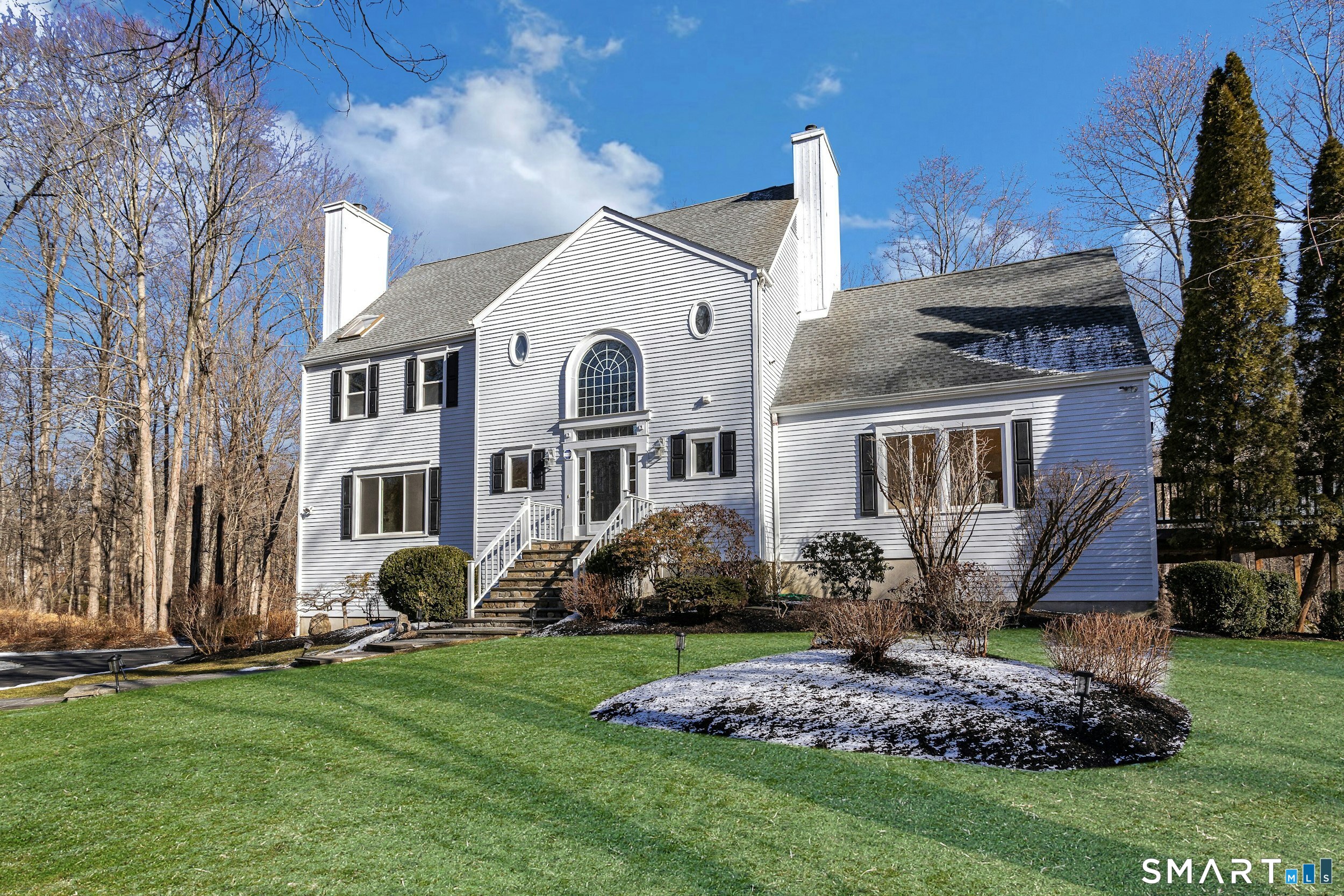 6 Morganti Court Ridgefield, CT 06877 - Photo 22 of 36 a front view of a house with a garden and plants