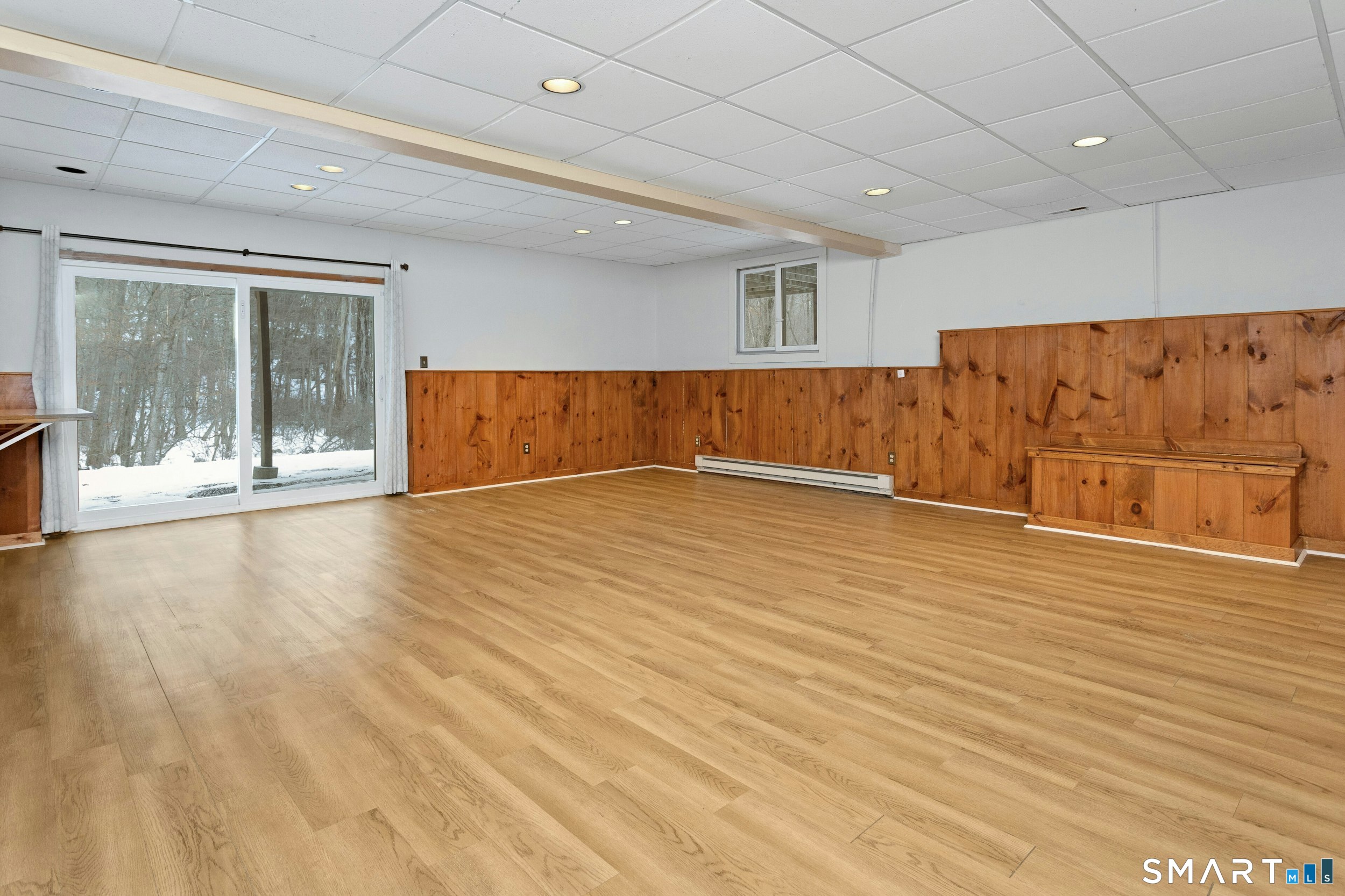 6 Morganti Court Ridgefield, CT 06877 - Photo 27 of 36 an empty room with wooden floor and windows
