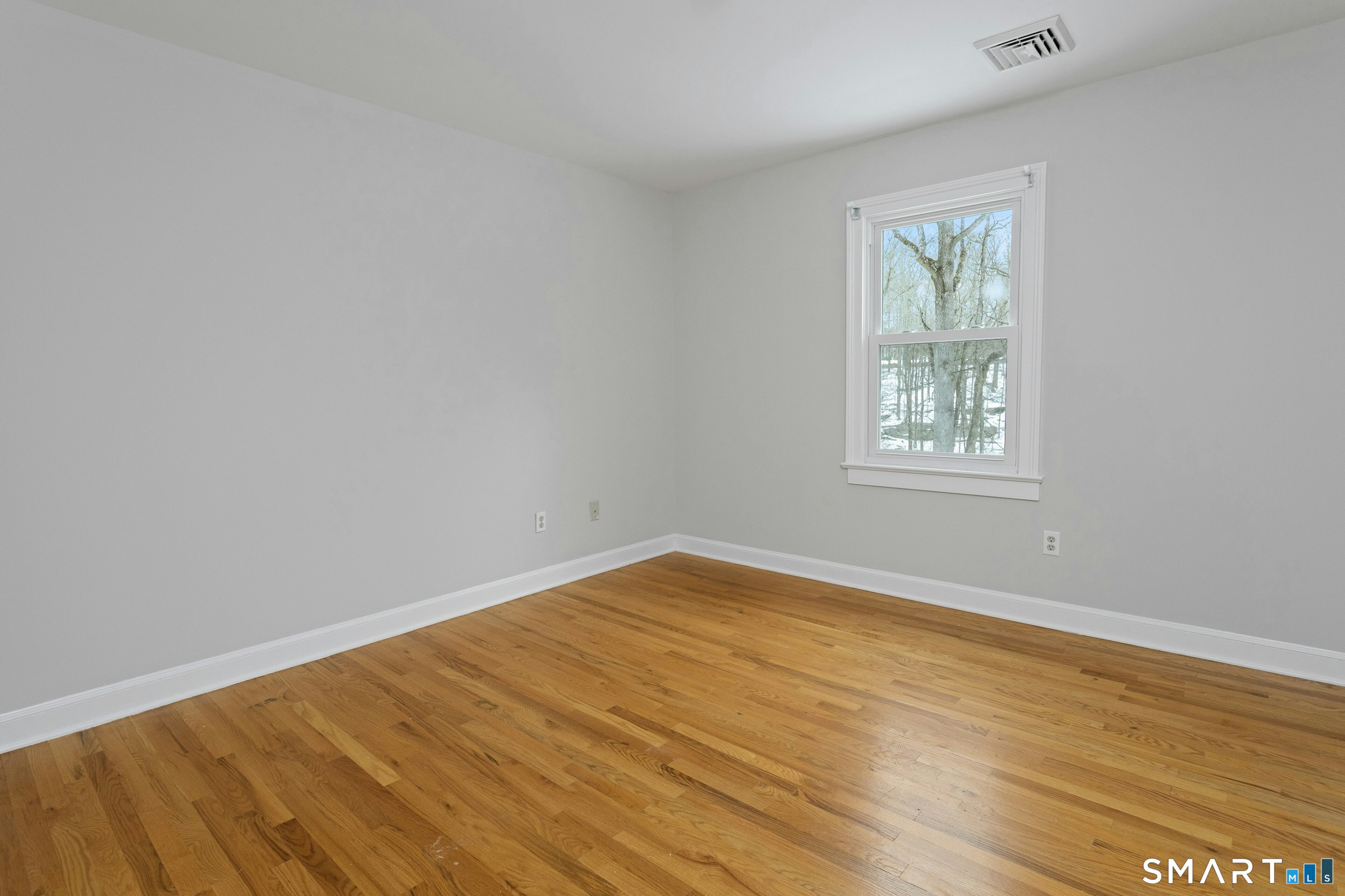 6 Morganti Court Ridgefield, CT 06877 - Photo 6 of 36 an empty room with wooden floor and windows