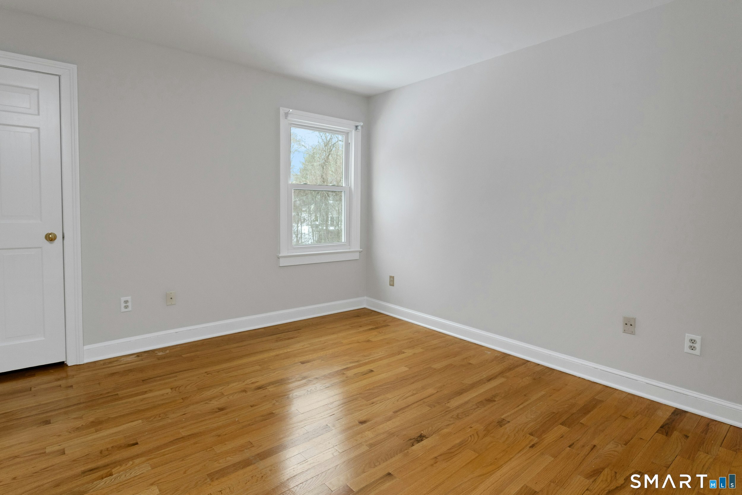 6 Morganti Court Ridgefield, CT 06877 - Photo 7 of 36 an empty room with wooden floor and windows
