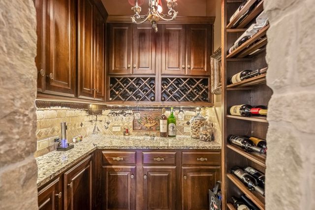 a kitchen with stainless steel appliances granite countertop a stove and cabinets