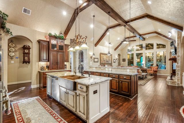 a kitchen with stainless steel appliances granite countertop a stove and a sink