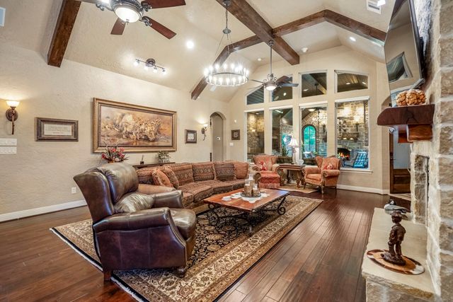 a room with pool table and windows