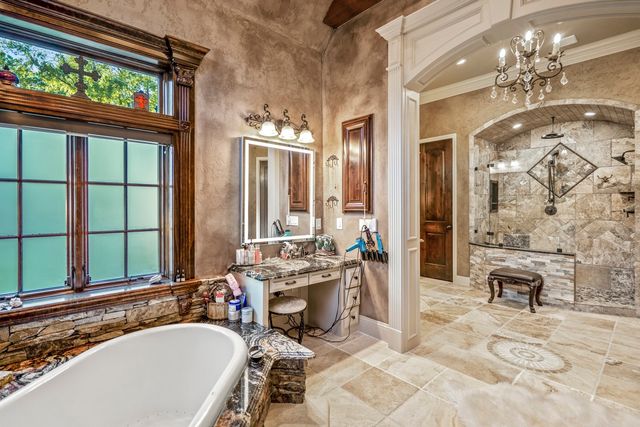 a bathroom with a sink a bathtub and a large mirror