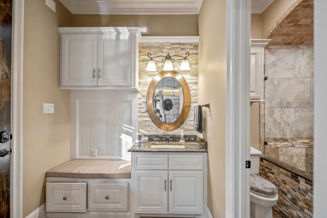 a view of a livingroom with a window and a ceiling fan