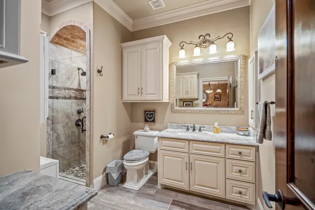 a view of a house with sitting area and covered with tall trees