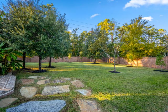 a view of a backyard with a garden and trees