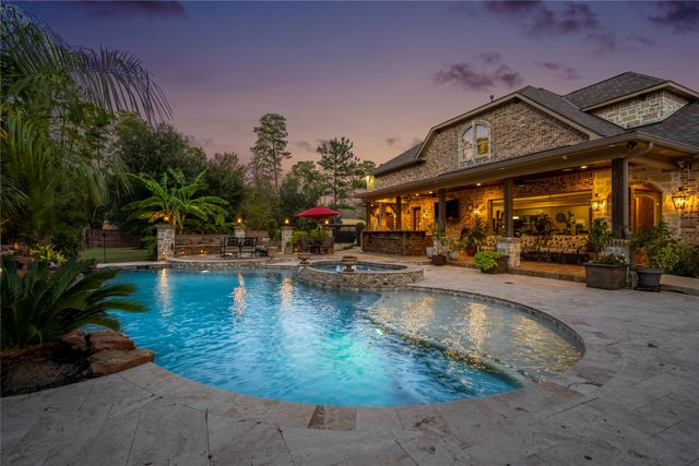 a view of a swimming pool with outdoor seating